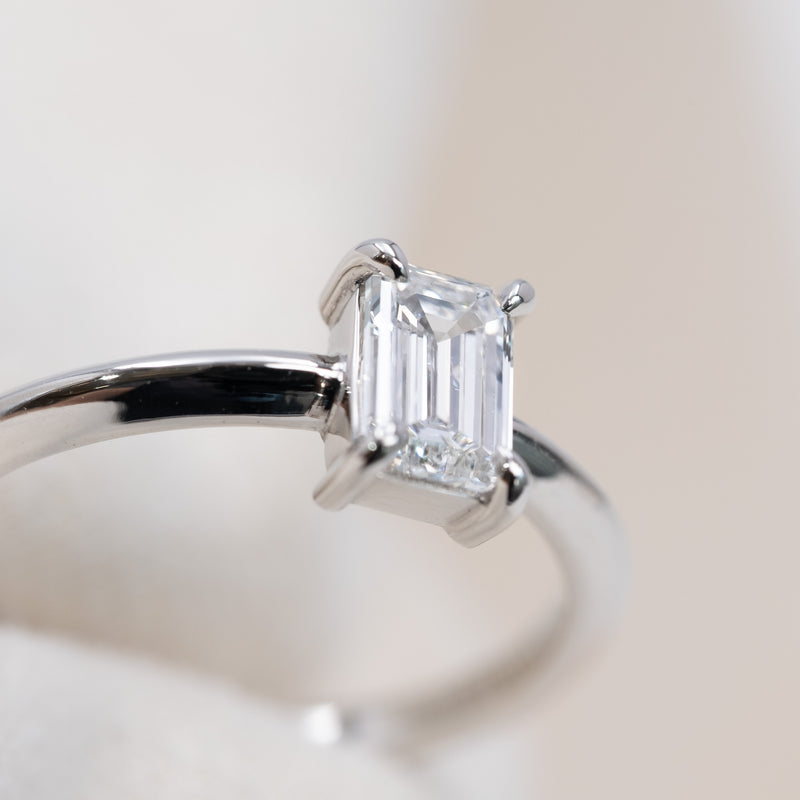 Emerald cut diamond knife edge ring