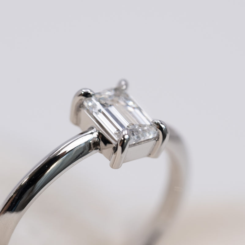Emerald cut diamond knife edge ring