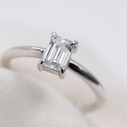 Emerald cut diamond knife edge ring