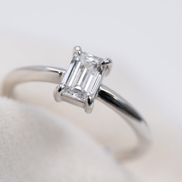 Emerald cut diamond knife edge ring